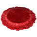 A red glass charger plate with a scalloped edge.