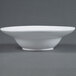 An American Metalcraft round white stoneware bowl on a gray surface.