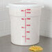 A white plastic Cambro food storage container with noodles and a red measuring spoon.