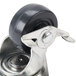 A metal swivel plate caster with a black rubber wheel.