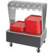An Advance Tabco stainless steel silverware stand on wheels with red trays on it.