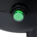 A green light on a black Avantco power switch.