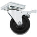 A black plate caster with a metal wheel.