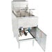 A Pitco stainless steel gas floor fryer with a large open door.