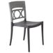 A black and grey plastic Grosfillex Moon stacking chair with a circular design.