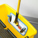 A yellow Rubbermaid mop bucket with a handle.