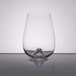 A close-up of a clear Stolzle stemless wine glass with a small amount of liquid in it.