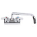 A chrome Equip by T&S wall mount swivel faucet with two handles and two faucets.