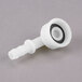 A white plastic Avantco male fitting with a black circle on the end.