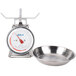 An Edlund stainless steel portion scale and bowl sitting on a counter.