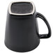 A black mug with a white handle.