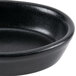 A black ceramic oval baker dish by Hall China on a table.