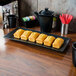 A Hall China black rectangular platter with bread on it.