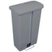 A gray plastic Rubbermaid Slim Jim trash can with a lid.
