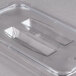 A clear plastic Carlisle StorPlus 1/4 size food pan lid with a handle and spoon notch.