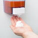 A person's hand using Advantage Chemicals foaming hand soap.