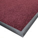 A burgundy carpet mat with a black border.