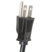 A black power cord with two plugs on it plugged into a metal object.