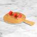 An Elite Global Solutions bamboo melamine serving board with watermelon slices on it.