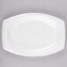 A Dart white laminated foam platter with a small oval shape.