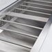 A close-up of an Avantco stainless steel refrigeration pan divider bar.