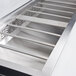 A close-up of a stainless steel Avantco refrigeration pan divider bar.