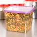 A clear plastic Cambro CamSquares container with spiral pasta and a purple lid.