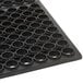 A black rubber mat with holes in it.