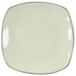 A white square Tuxton china pasta plate with gold trim.