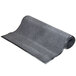A roll of charcoal carpet with a curved edge on a white background.