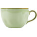 A close-up of a Tuxton TuxTrendz sagebrush green china cup with a handle.