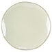 A white Tuxton Artisan china plate with a sagebrush design on the white rim.