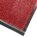 A red carpet entrance mat with black edges.
