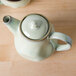 A TuxTrendz Artisan Sagebrush teapot lid on a teapot.