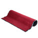 A rolled up red carpet with black trim.