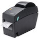 A black Tor Rey DT-2 thermal label printer printing a white label.