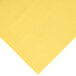 A yellow plastic table cover on a white surface.