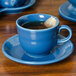 A Lapis blue Fiesta saucer with a blue tea cup on it.