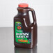 A brown plastic bottle of Kikkoman Hoisin Sauce on a counter.