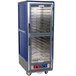A blue and silver Metro C5 heated holding and proofing cabinet with clear Dutch doors.