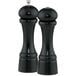 Two black Chef Specialties pepper mills with white caps.