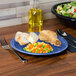 A Lapis Fiesta® Dinnerware plate with food on a table.