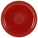 A close-up of a Fiesta® Healthcare China plate in red with a circular design in the middle.