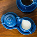 A Fiesta Lapis sugar and creamer tray with white liquid in the creamer.