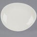 A Tuxton eggshell white china plate on a gray background.
