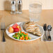 A Tuxton Healthcare 3-compartment china plate with a grilled chicken breast, fruit, and utensils.