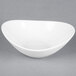 A Tuxton porcelain white Capistrano bowl with a small rim.