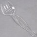 A clear plastic Fineline serving fork.