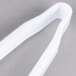 White plastic serving tongs with a white handle.