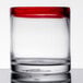 A Libbey rocks glass with a red rim.